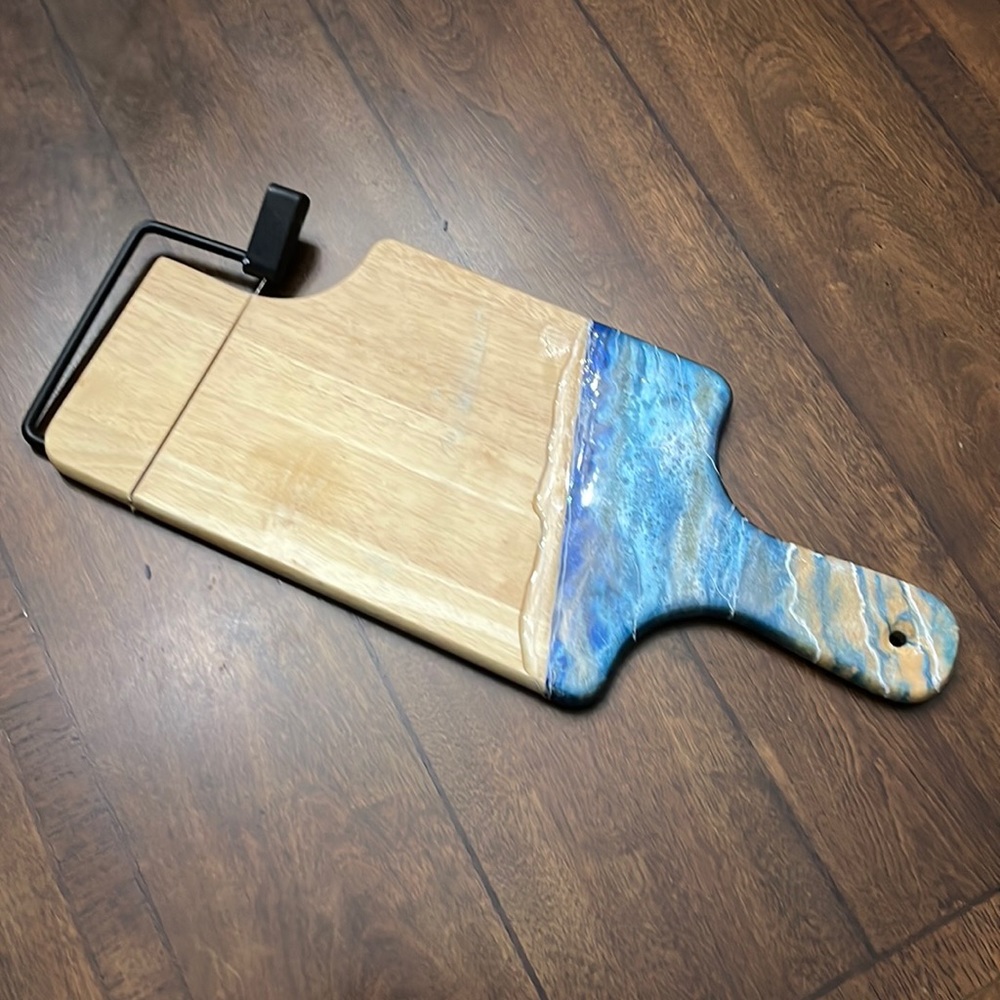 Cheese board with wire cutter